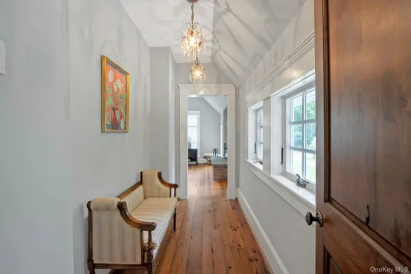 a hallway with furniture and wooden floor