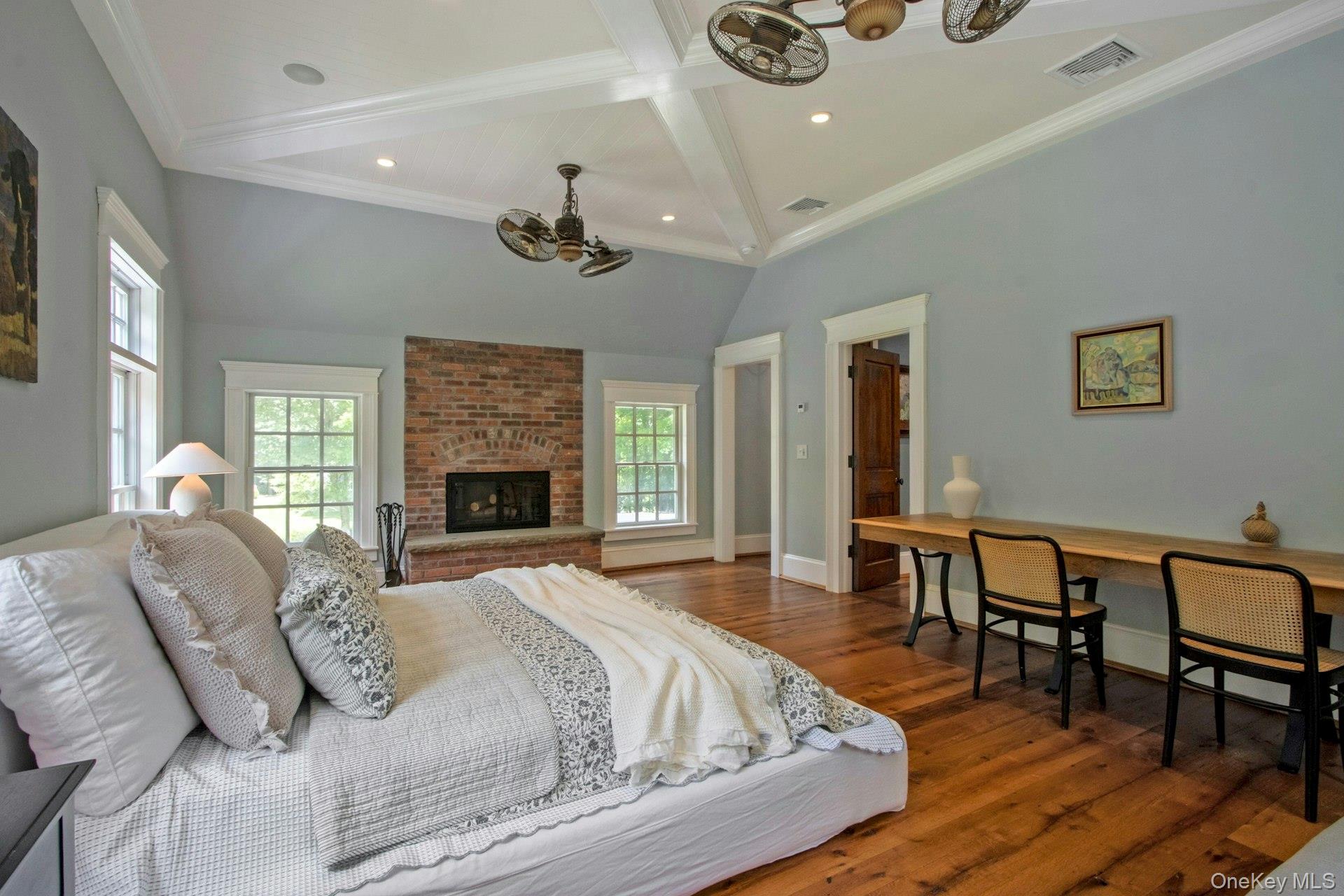 314 Haverstraw Road Suffern, NY 10901 - Photo 20 of 44 Bedroom featuring a chandelier, multiple windows, wood finished floors, a fireplace, and recessed lighting