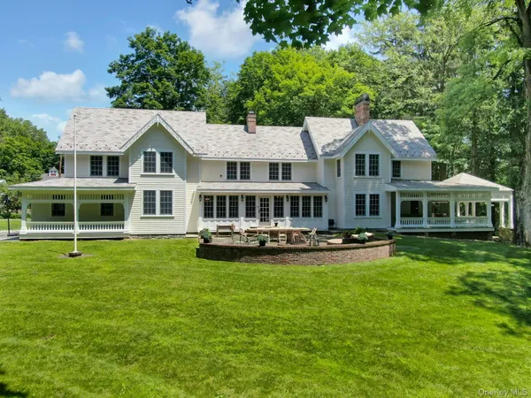 a aerial view of a house with swimming pool next to a big yard