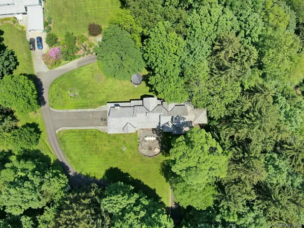 an aerial view of a house with a garden and trees
