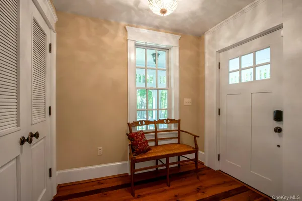 a view of a room with wooden floor and windows