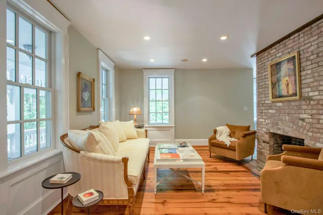 a living room with furniture fireplace and a large window