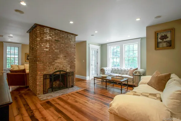 a living room with furniture fireplace and flat screen tv