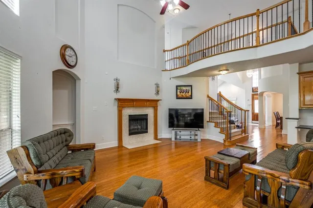 a living room with furniture a fireplace and a flat screen tv
