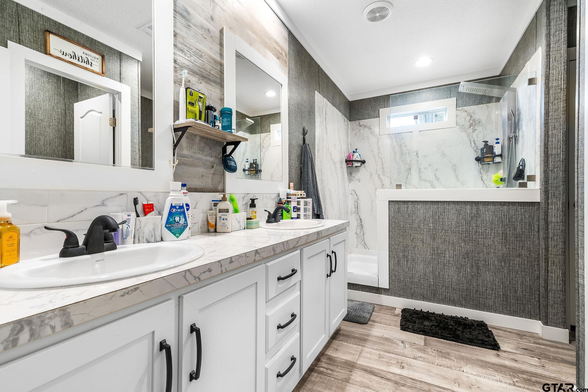 1255 Raintree Lakes Circle Big Sandy, TX 75755 - Photo 12 of 27 a spacious bathroom with a double vanity sink and a mirror