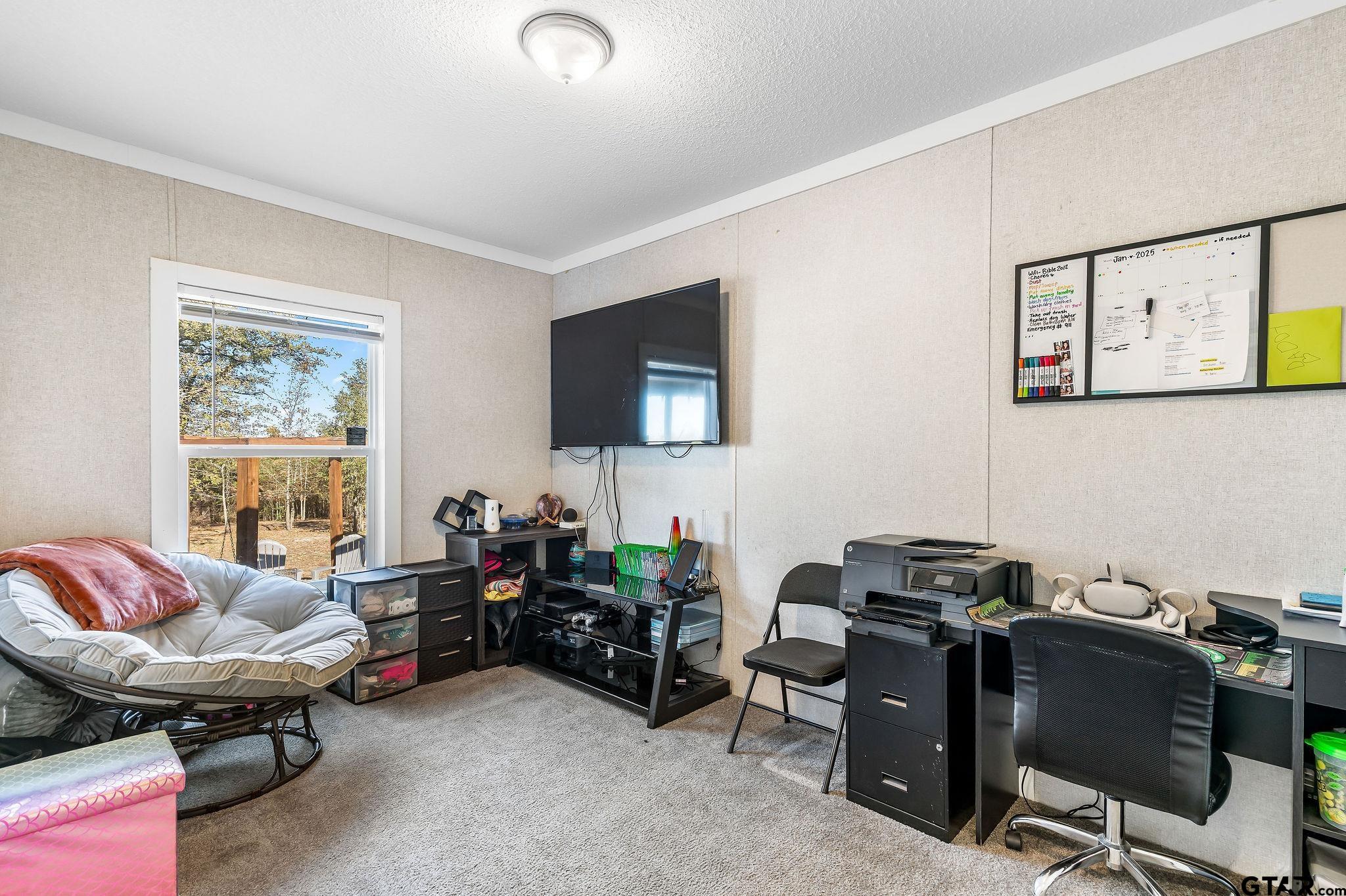1255 Raintree Lakes Circle Big Sandy, TX 75755 - Photo 16 of 28 a livingroom with workspace and a window