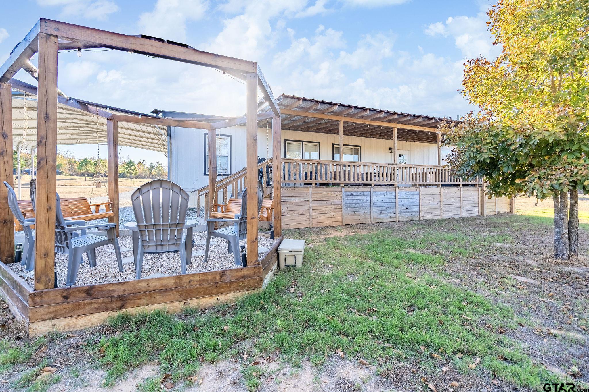 1255 Raintree Lakes Circle Big Sandy, TX 75755 - Photo 21 of 27 a view of a house with backyard and a tree