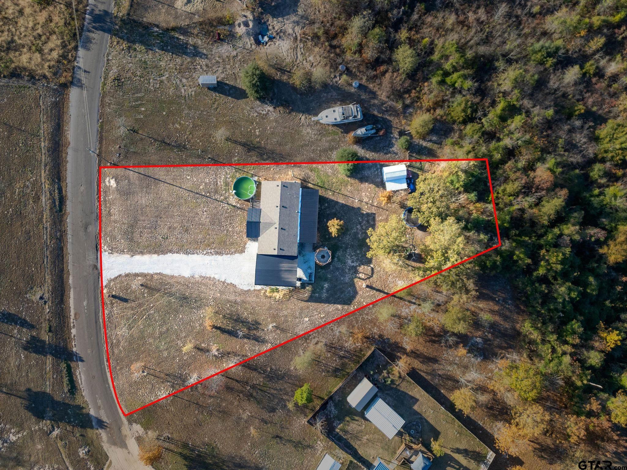 1255 Raintree Lakes Circle Big Sandy, TX 75755 - Photo 28 of 28 a view of a house with a tree