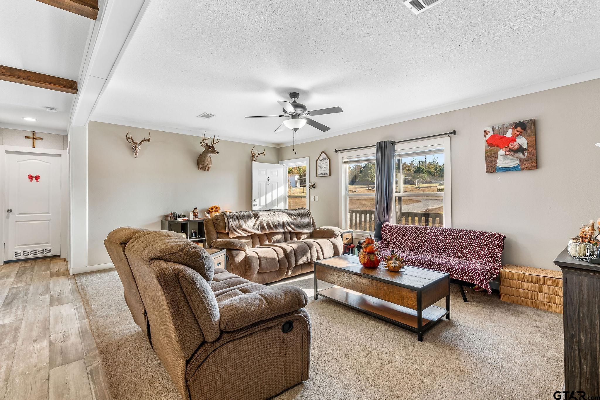 1255 Raintree Lakes Circle Big Sandy, TX 75755 - Photo 5 of 28 a living room with furniture and a chandelier