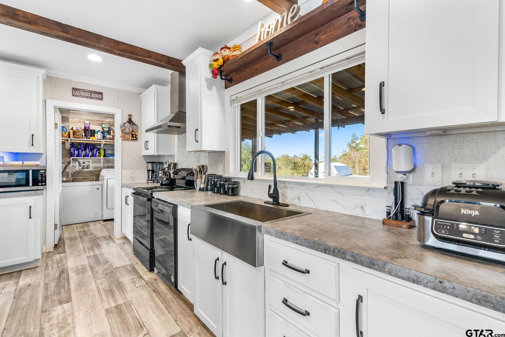 1255 Raintree Lakes Circle Big Sandy, TX 75755 - Photo 6 of 28 a kitchen with granite countertop a sink a counter space appliances and cabinets