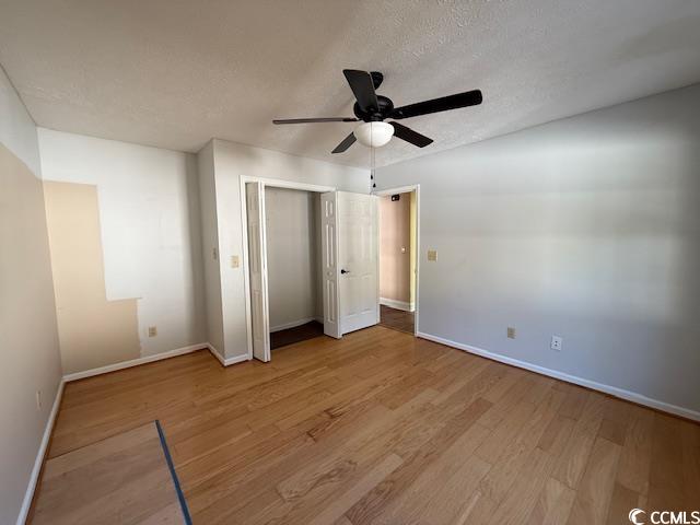 983 Nottingham Lakes Road Conway, SC 29526 - Photo 11 of 27 Unfurnished bedroom with light wood-type flooring, a ceiling fan, a textured ceiling, and a closet