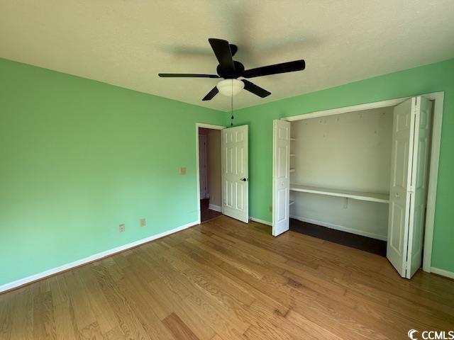 983 Nottingham Lakes Road Conway, SC 29526 - Photo 13 of 27 Unfurnished bedroom with wood finished floors, a closet, and ceiling fan