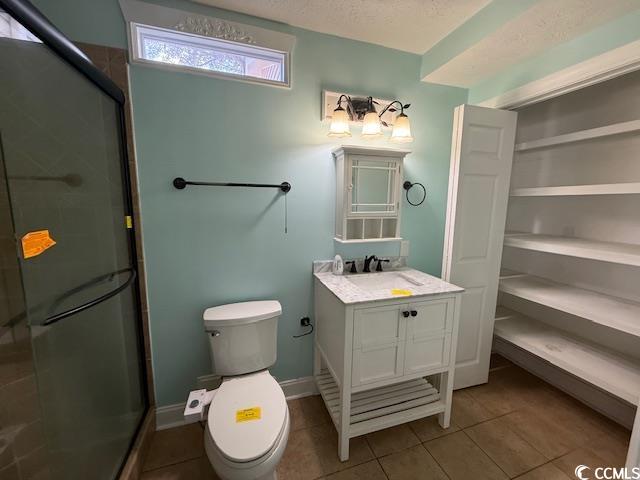 983 Nottingham Lakes Road Conway, SC 29526 - Photo 16 of 27 Full bathroom with vanity, a shower stall, light tile patterned flooring, and a textured ceiling
