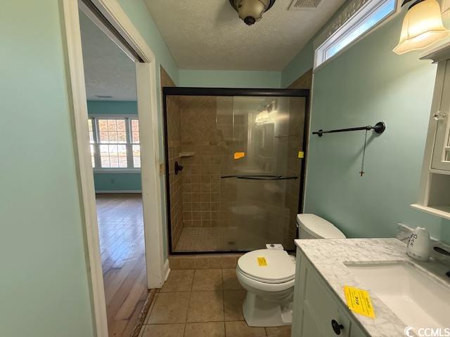 983 Nottingham Lakes Road Conway, SC 29526 - Photo 18 of 27 Full bathroom featuring plenty of natural light, vanity, a shower stall, light tile patterned flooring, and a textured ceiling