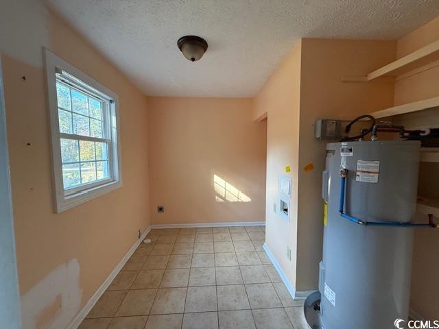 983 Nottingham Lakes Road Conway, SC 29526 - Photo 20 of 27 Washroom featuring electric water heater, a textured ceiling, light tile patterned flooring, and electric dryer hookup