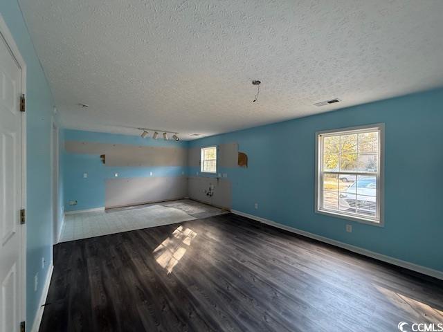 983 Nottingham Lakes Road Conway, SC 29526 - Photo 21 of 27 Empty room featuring a textured ceiling and dark wood-style floors