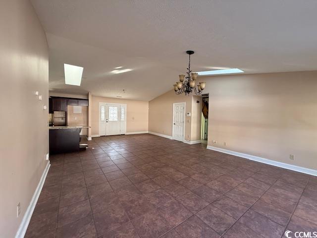 983 Nottingham Lakes Road Conway, SC 29526 - Photo 4 of 27 Unfurnished living room featuring a skylight, vaulted ceiling, and a chandelier