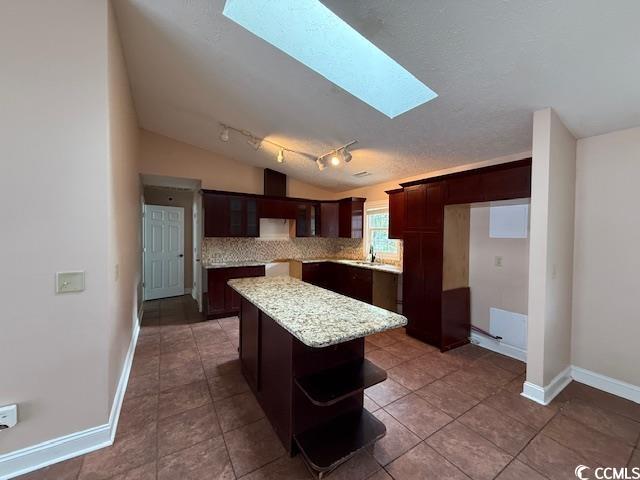 983 Nottingham Lakes Road Conway, SC 29526 - Photo 6 of 27 Kitchen featuring a skylight, dark brown cabinetry, a kitchen island, open shelves, and track lighting