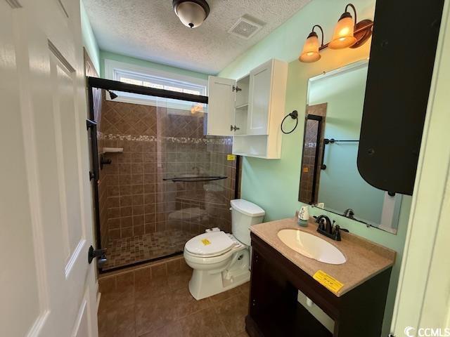 983 Nottingham Lakes Road Conway, SC 29526 - Photo 8 of 27 Bathroom with vanity, a textured ceiling, a stall shower, and dark tile patterned floors