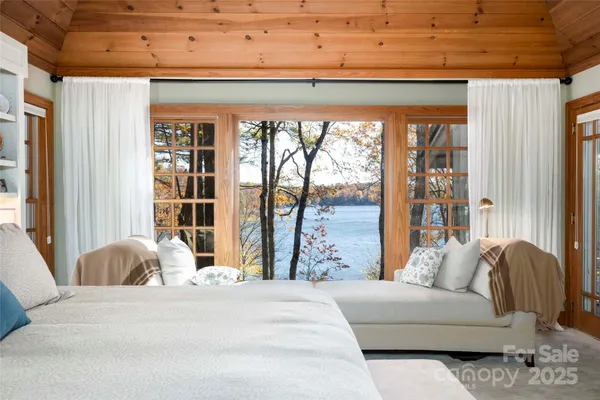 a living room with furniture and large windows