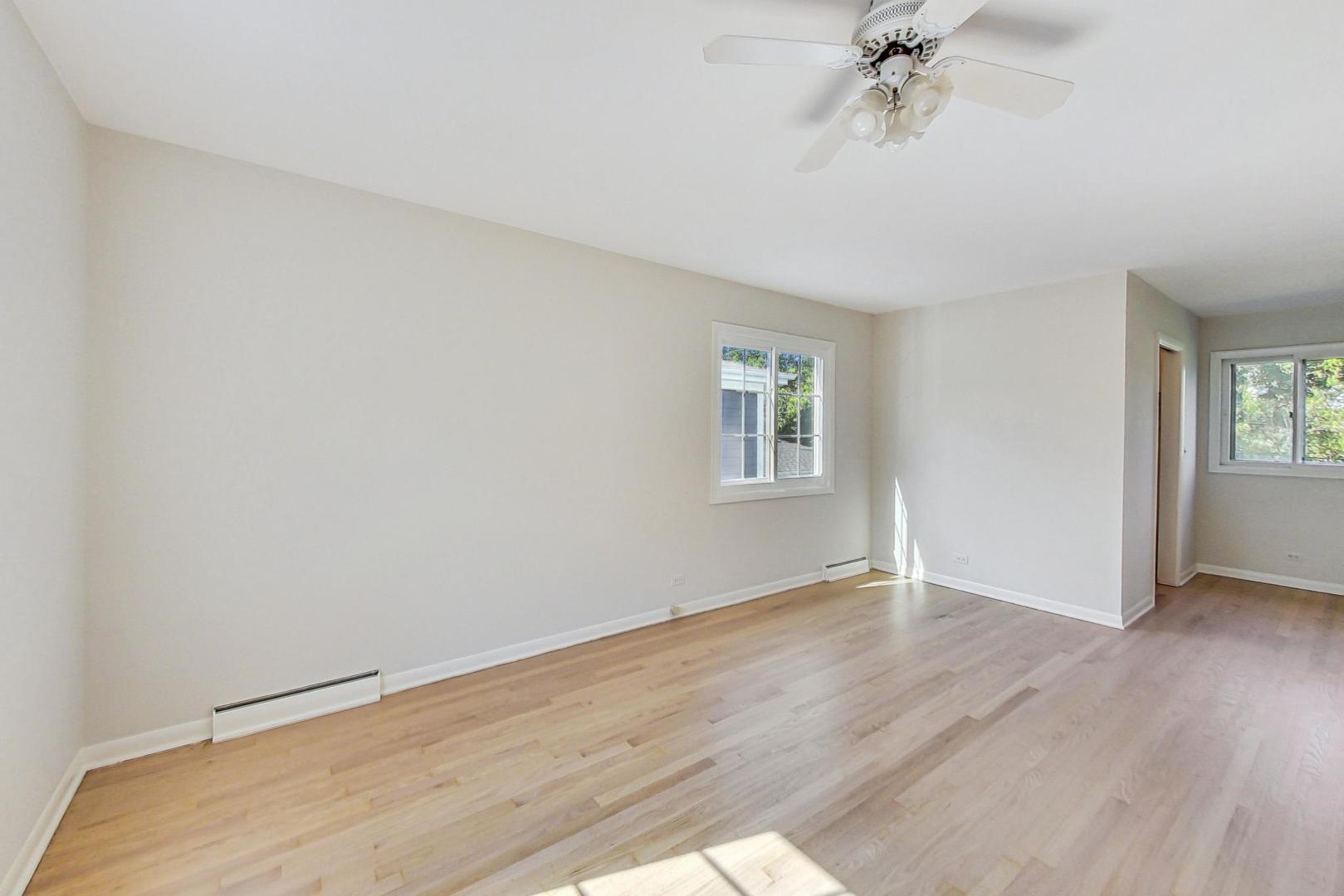 157 Riverside Drive Northfield, IL 60093 - Photo 11 of 21 an empty room with wooden floor closet and windows
