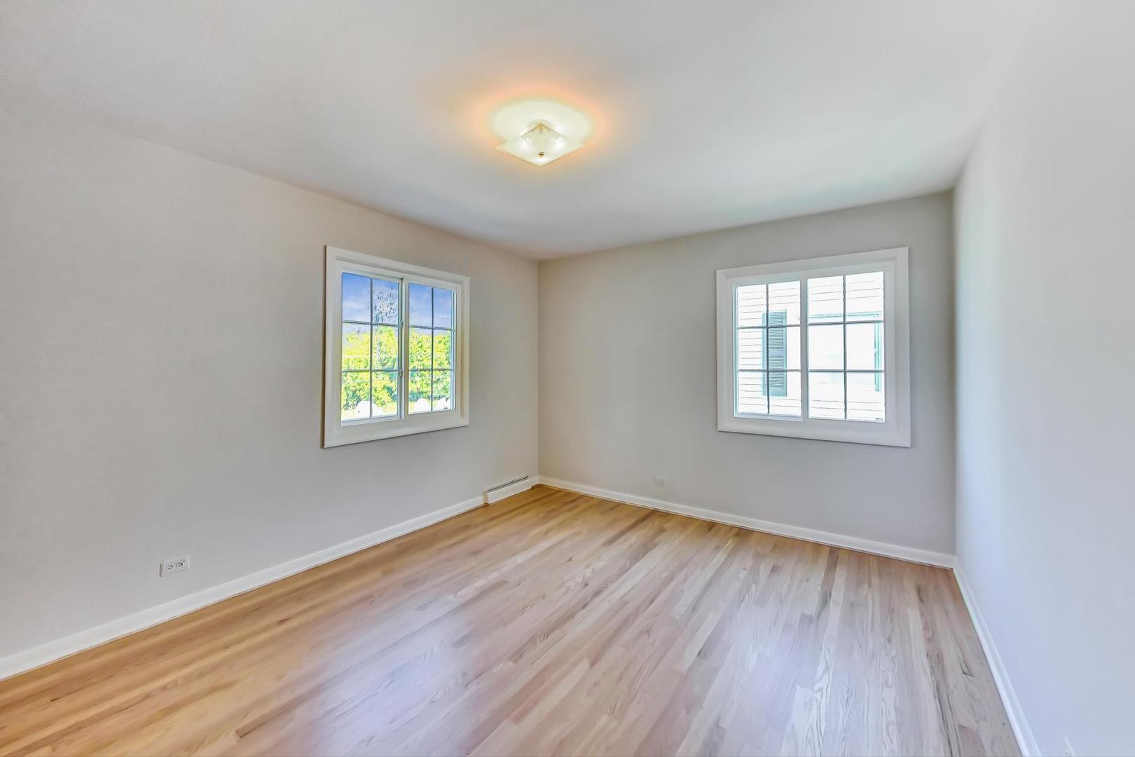 157 Riverside Drive Northfield, IL 60093 - Photo 14 of 21 an empty room with wooden floor and windows