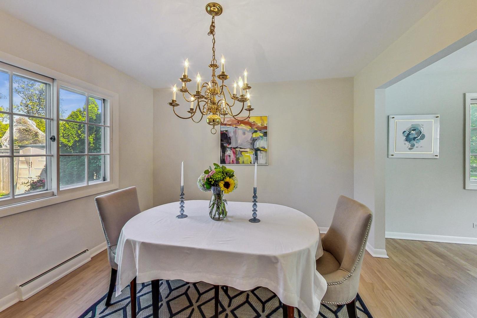 157 Riverside Drive Northfield, IL 60093 - Photo 6 of 21 a view of a dining room with furniture a chandelier and wooden floor