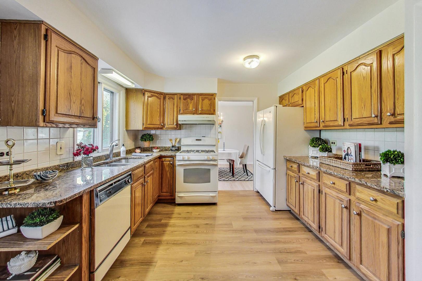 157 Riverside Drive Northfield, IL 60093 - Photo 7 of 21 a kitchen with stainless steel appliances granite countertop a stove a sink dishwasher and a refrigerator