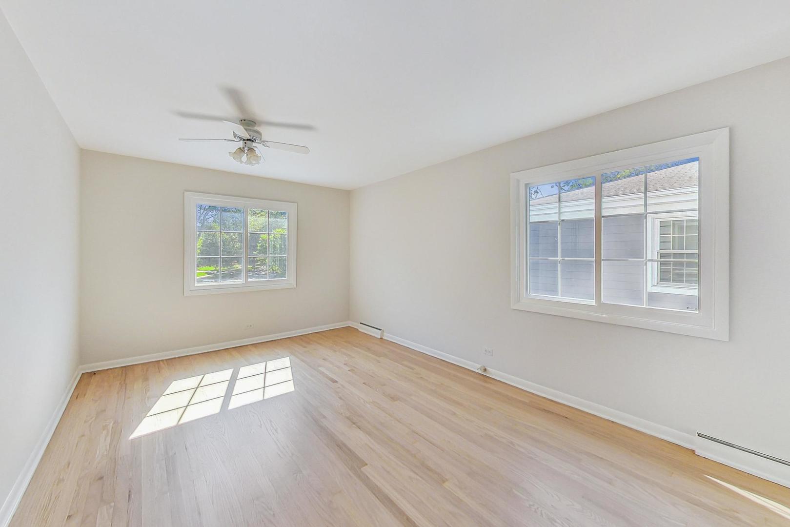 157 Riverside Drive Northfield, IL 60093 - Photo 10 of 21 a view of empty room with wooden floor and fan