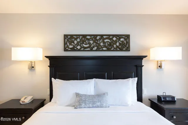 a bedroom with a large bed and a flat screen tv