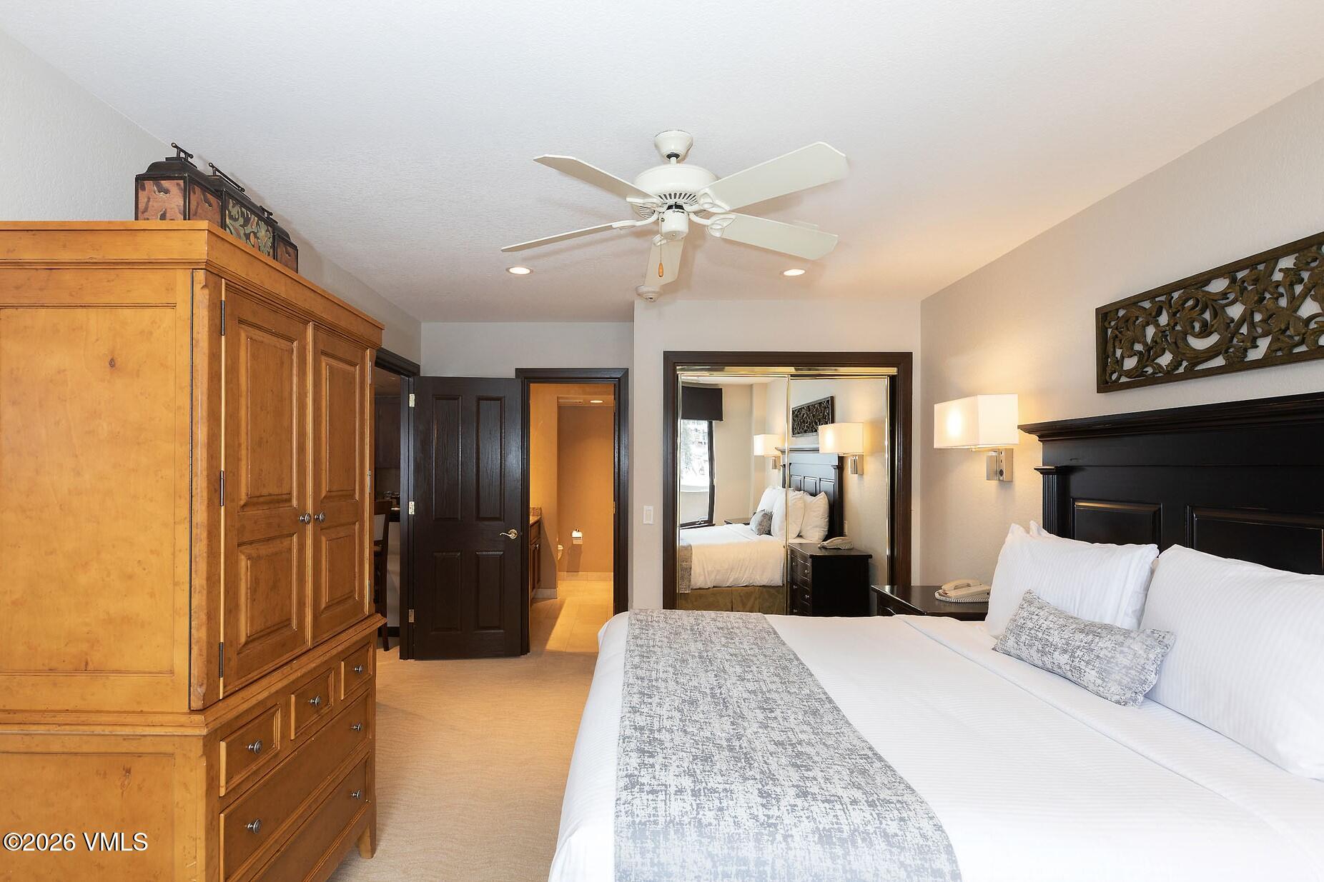 210 Offerson Road, Unit R305 WEEK 14 Beaver Creek, CO 81620 - Photo 13 of 24 a bedroom with a bed and dresser with mirror