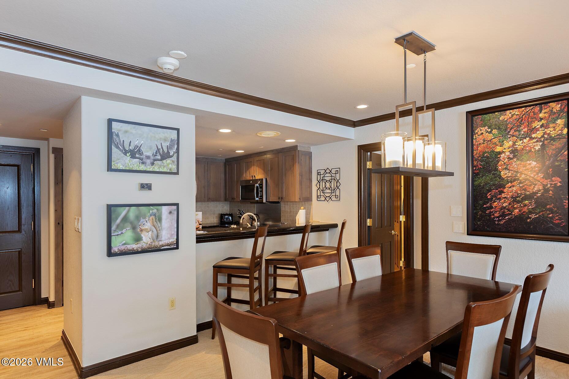210 Offerson Road, Unit R305 WEEK 14 Beaver Creek, CO 81620 - Photo 7 of 24 a view of a dining room with furniture window and wooden floor