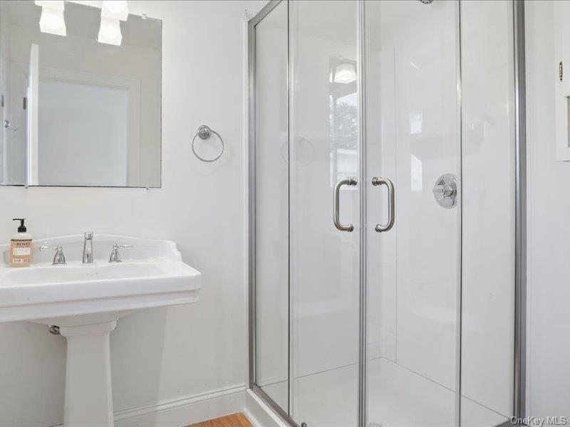 12 Summit Boulevard Westhampton, NY 11977 - Photo 13 of 17 a bathroom with a sink a mirror a vanity and shower
