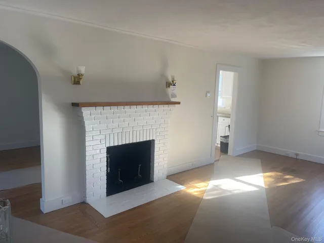 a view of empty room with a fireplace