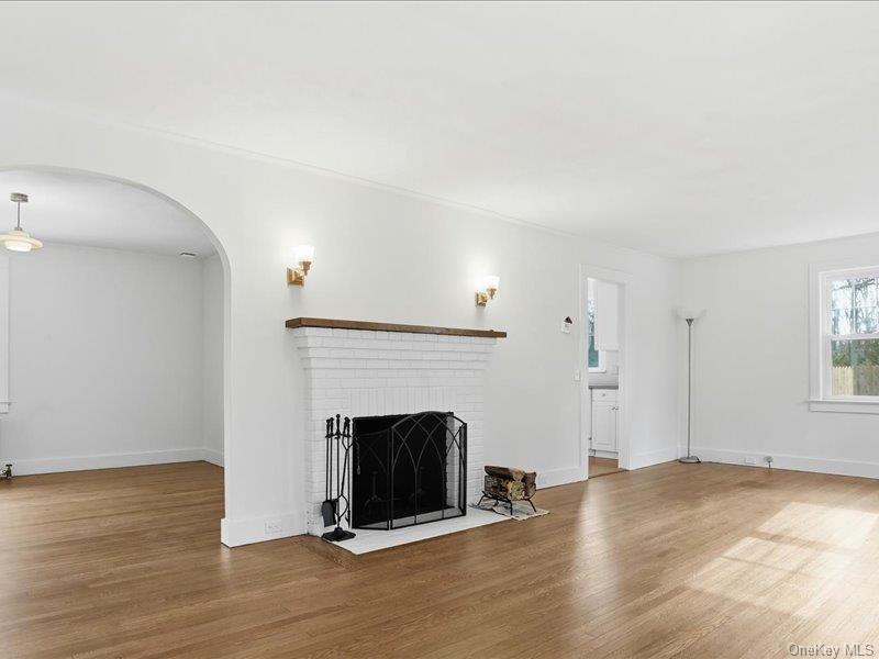 12 Summit Boulevard Westhampton, NY 11977 - Photo 4 of 17 a view of an empty room with wooden floor and a fireplace