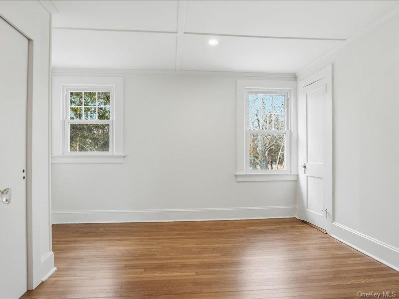 12 Summit Boulevard Westhampton, NY 11977 - Photo 10 of 17 a view of an empty room with wooden floor and a window