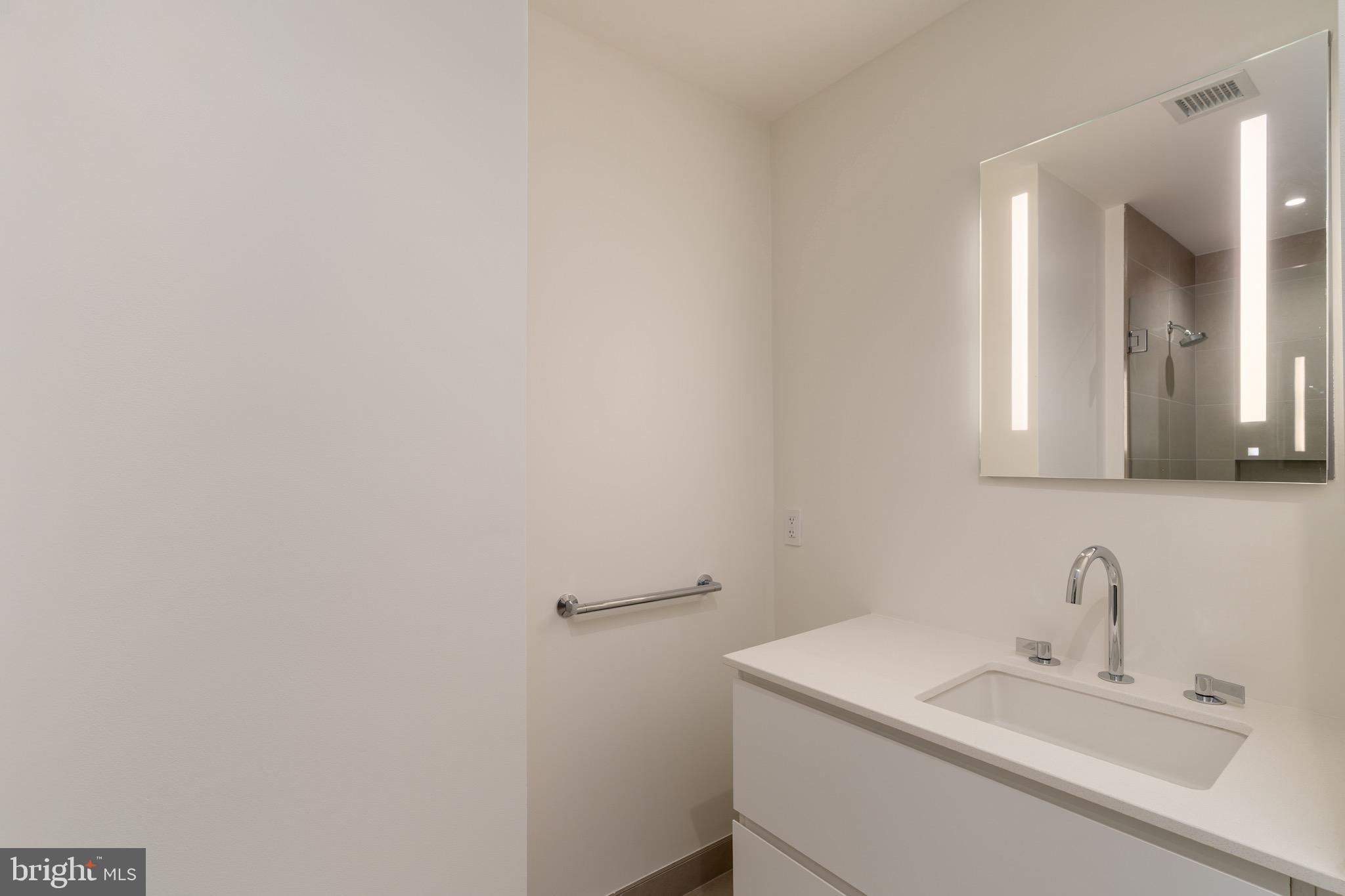 1630 Columbia Road Northwest, Unit 904 Washington, DC 20009 - Photo 5 of 20 a bathroom with a sink and a mirror