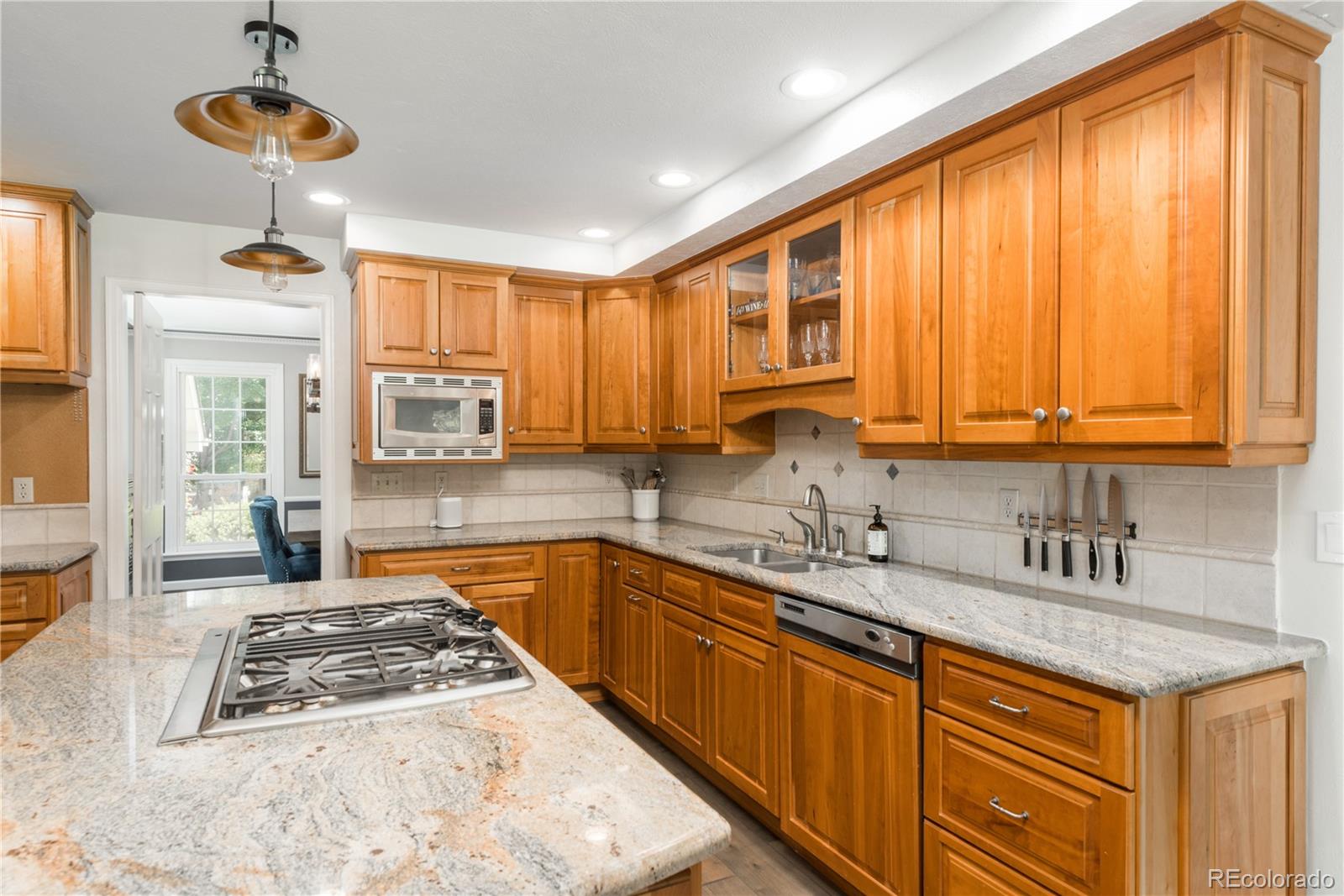 7 Middlefield Road Littleton, CO 80123 - Photo 12 of 39 a kitchen with stainless steel appliances granite countertop a sink stove and cabinets