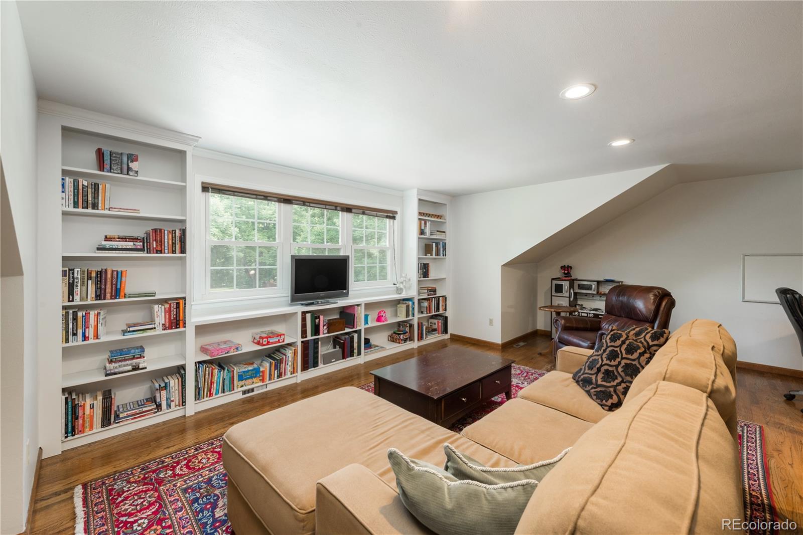 7 Middlefield Road Littleton, CO 80123 - Photo 20 of 39 a living room with furniture and a flat screen tv
