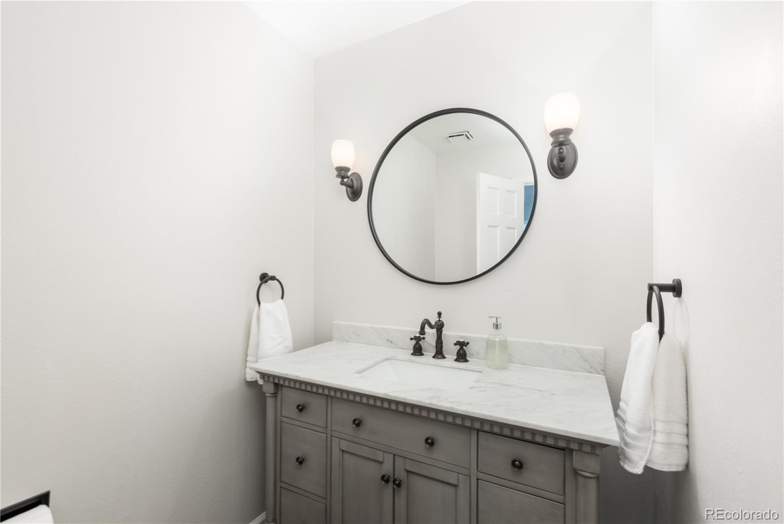 7 Middlefield Road Littleton, CO 80123 - Photo 22 of 39 a bathroom with a sink and a mirror