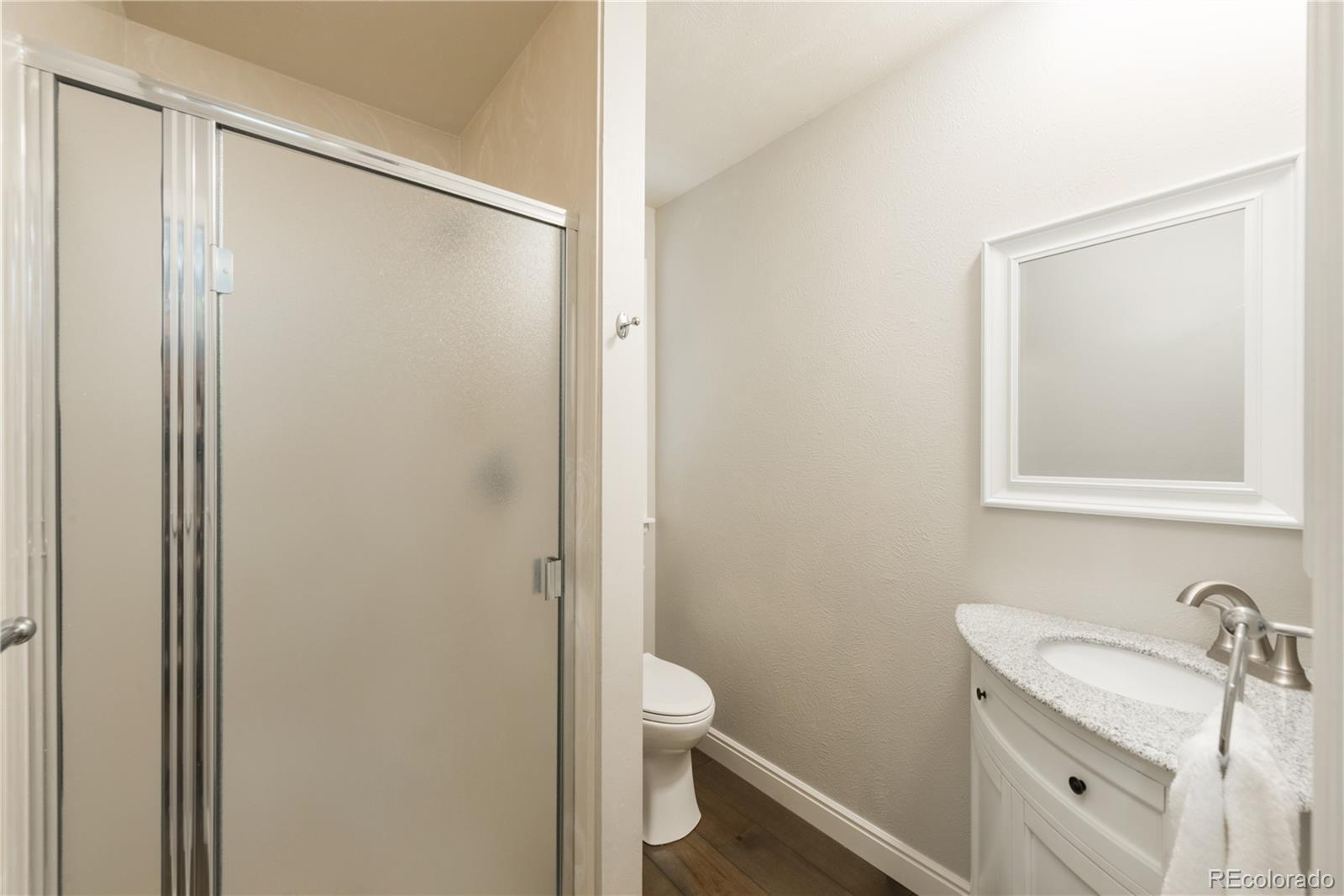 7 Middlefield Road Littleton, CO 80123 - Photo 24 of 39 a bathroom with a granite countertop sink toilet and shower
