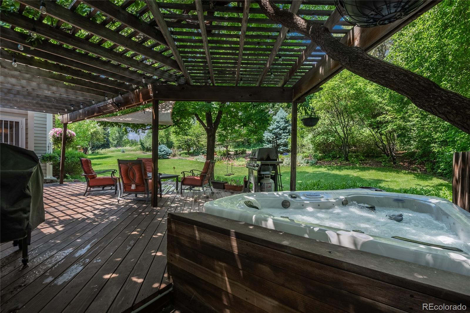 7 Middlefield Road Littleton, CO 80123 - Photo 32 of 39 a patio view with a table and chairs with wooden floor and fence