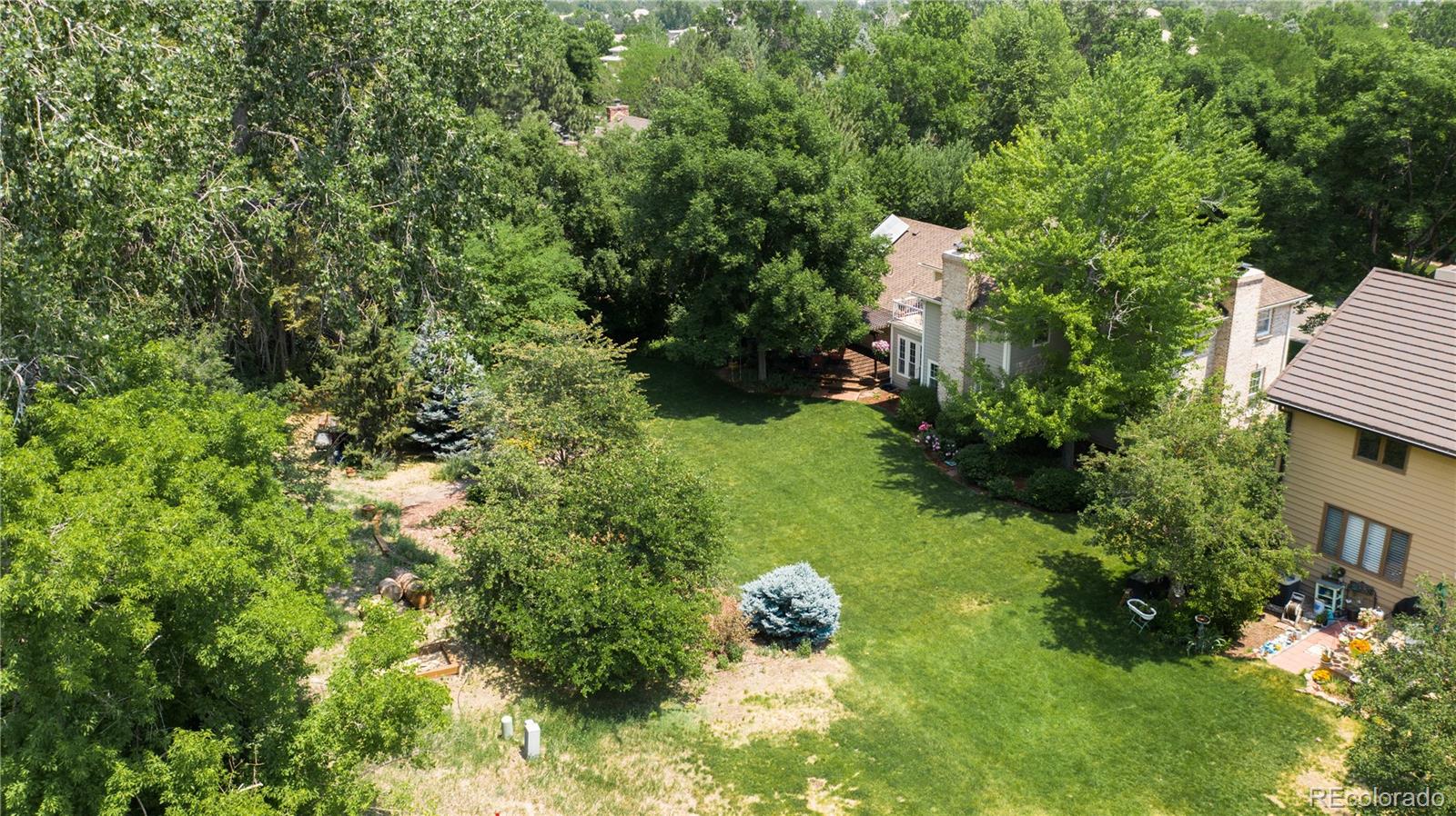 7 Middlefield Road Littleton, CO 80123 - Photo 35 of 39 a backyard of a house with lots of green space and garden