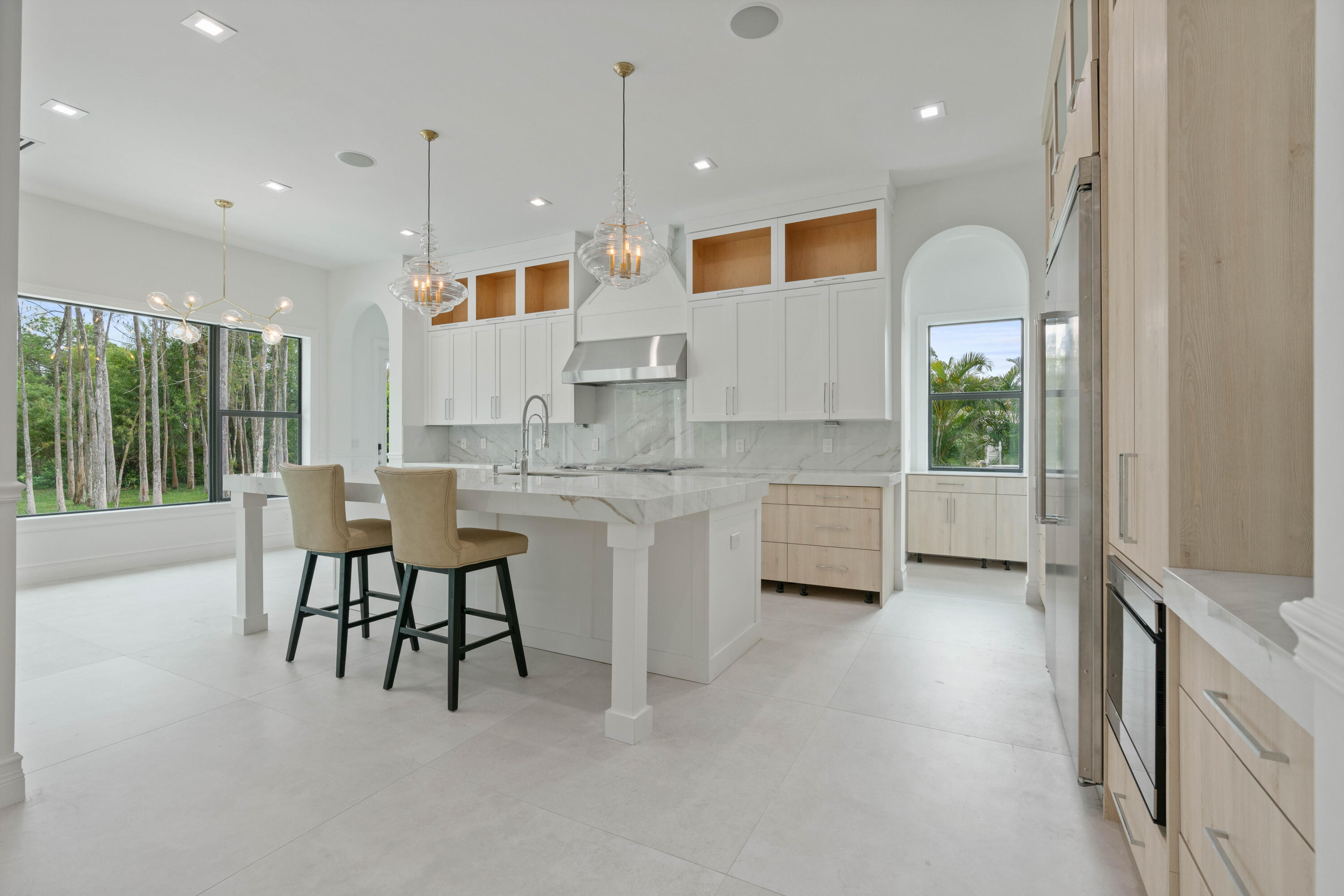 17794 Mellen Lane Jupiter, FL 33478 - Photo 19 of 45 a kitchen with kitchen island a table and chairs in it