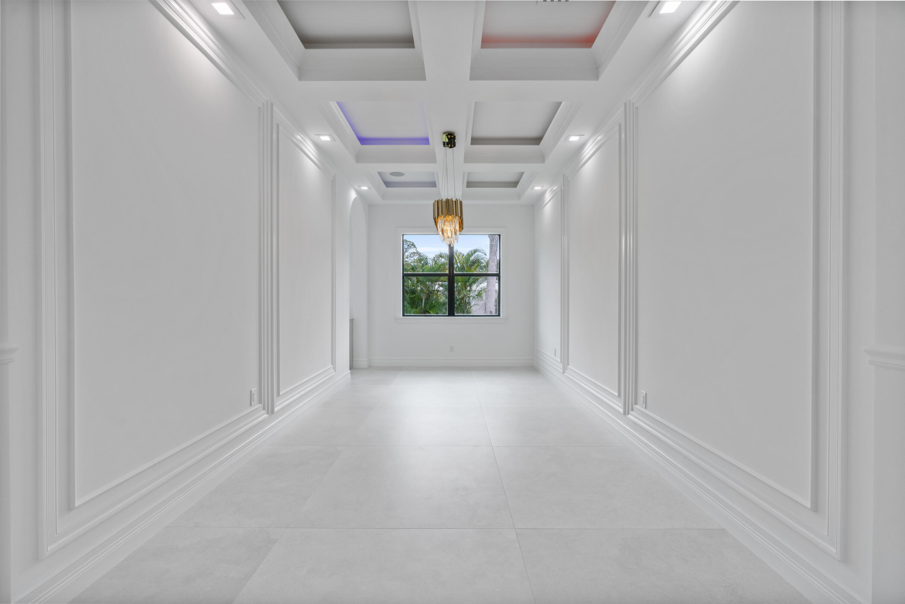 17794 Mellen Lane Jupiter, FL 33478 - Photo 21 of 45 en empty room with windows and chandelier