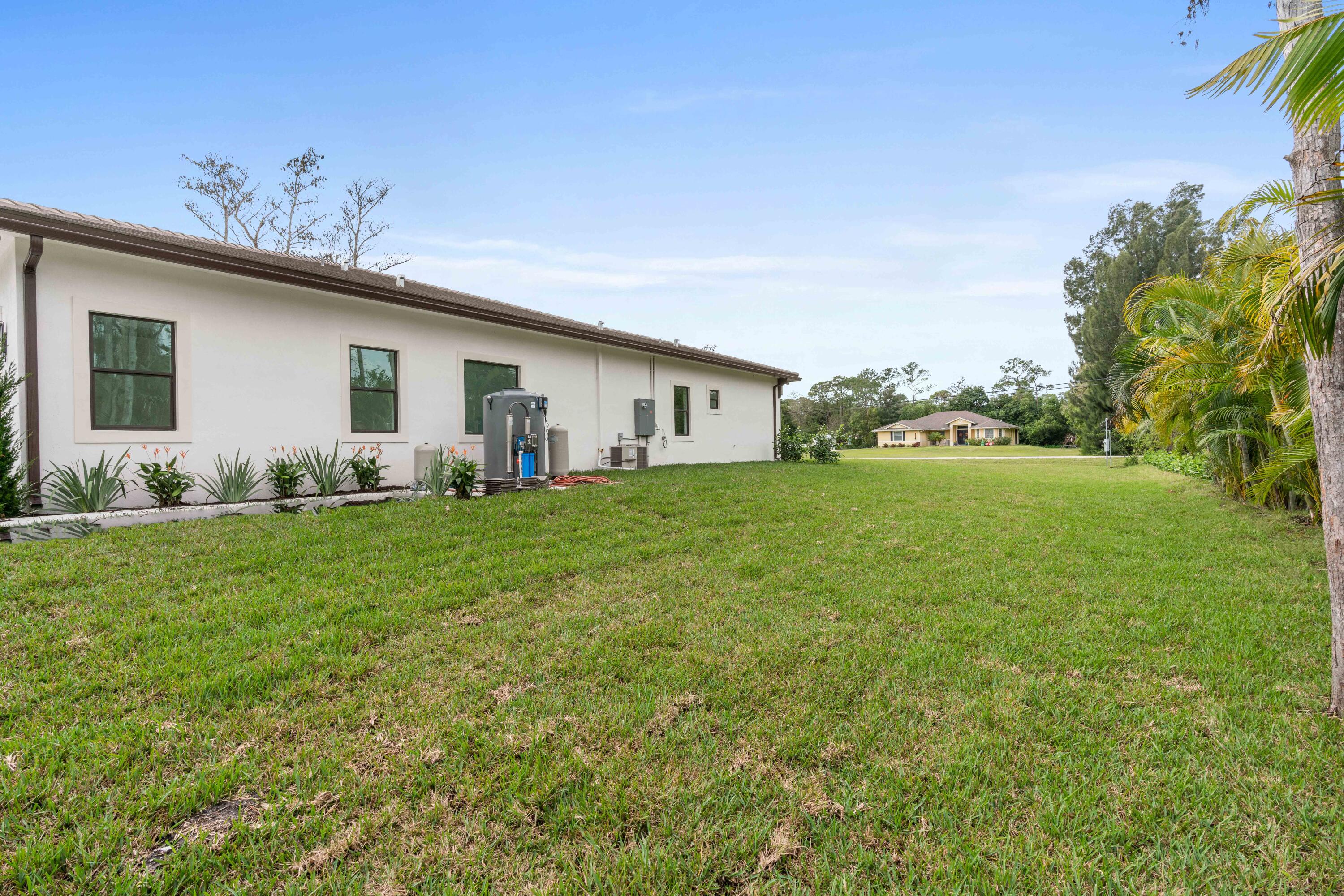 17794 Mellen Lane Jupiter, FL 33478 - Photo 25 of 45 a big white house with a yard