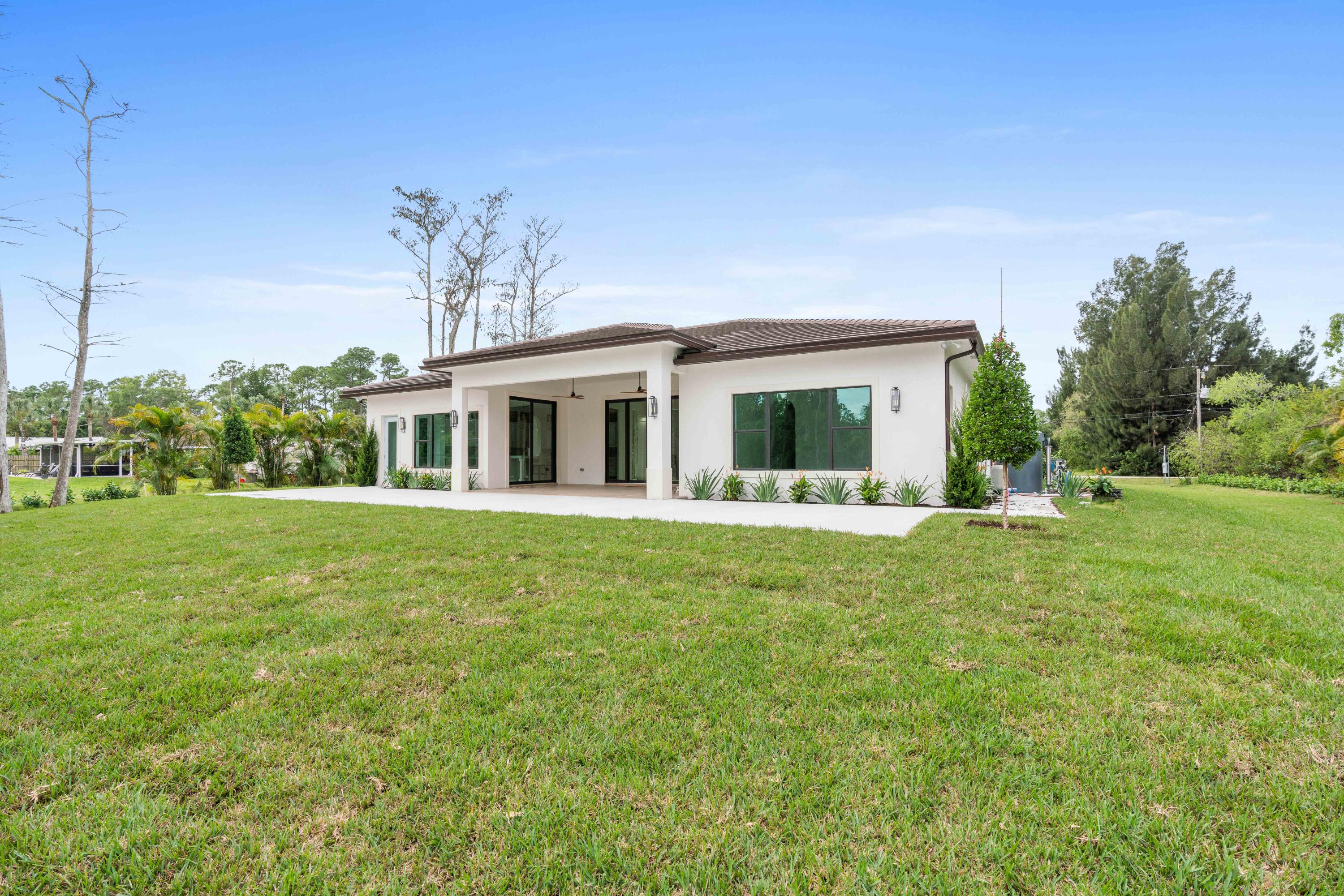 17794 Mellen Lane Jupiter, FL 33478 - Photo 26 of 45 a view of house that has a backyard