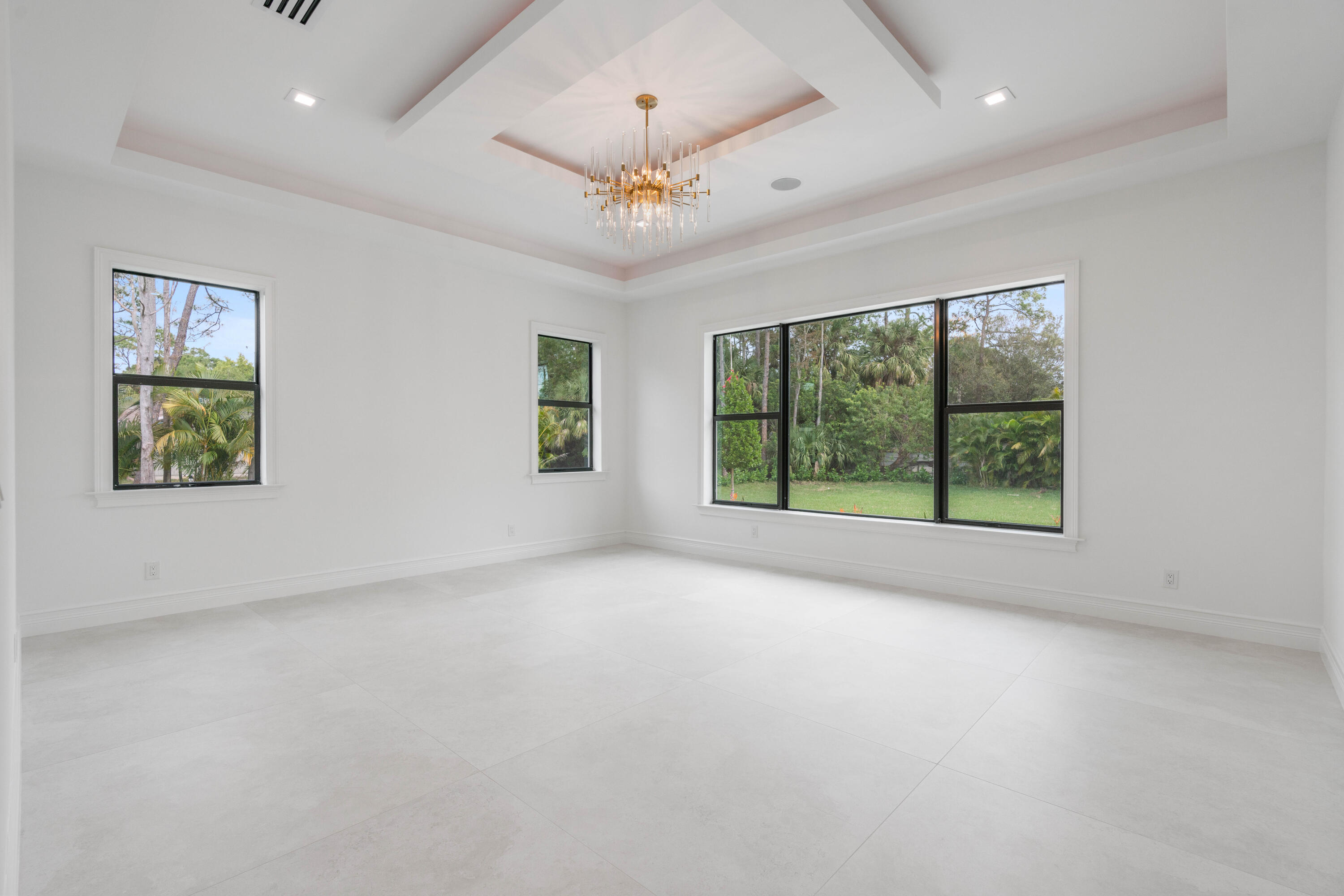 17794 Mellen Lane Jupiter, FL 33478 - Photo 30 of 45 en empty room with windows and ceiling fan