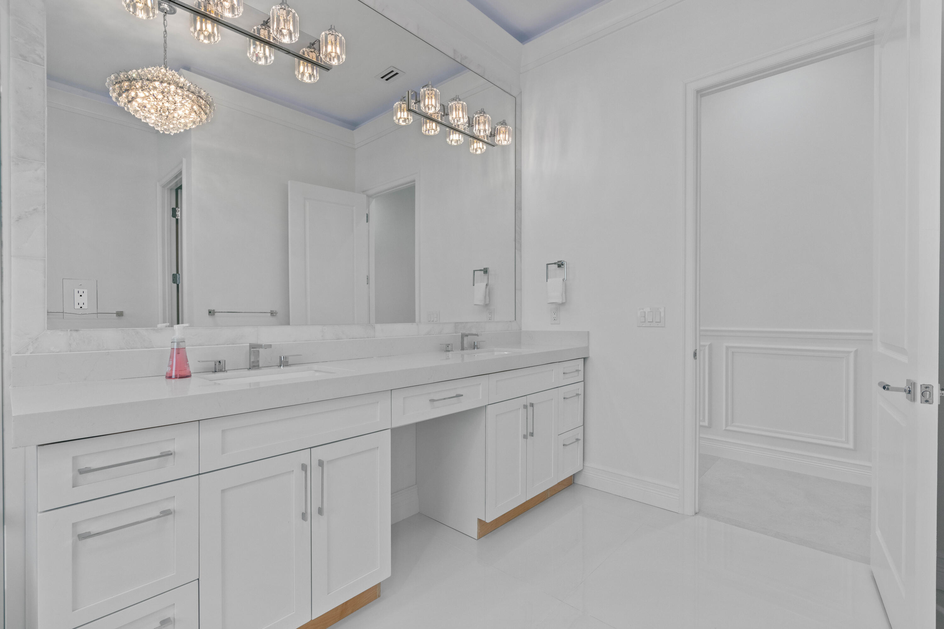 17794 Mellen Lane Jupiter, FL 33478 - Photo 32 of 45 a bathroom with a double vanity sink and a mirror