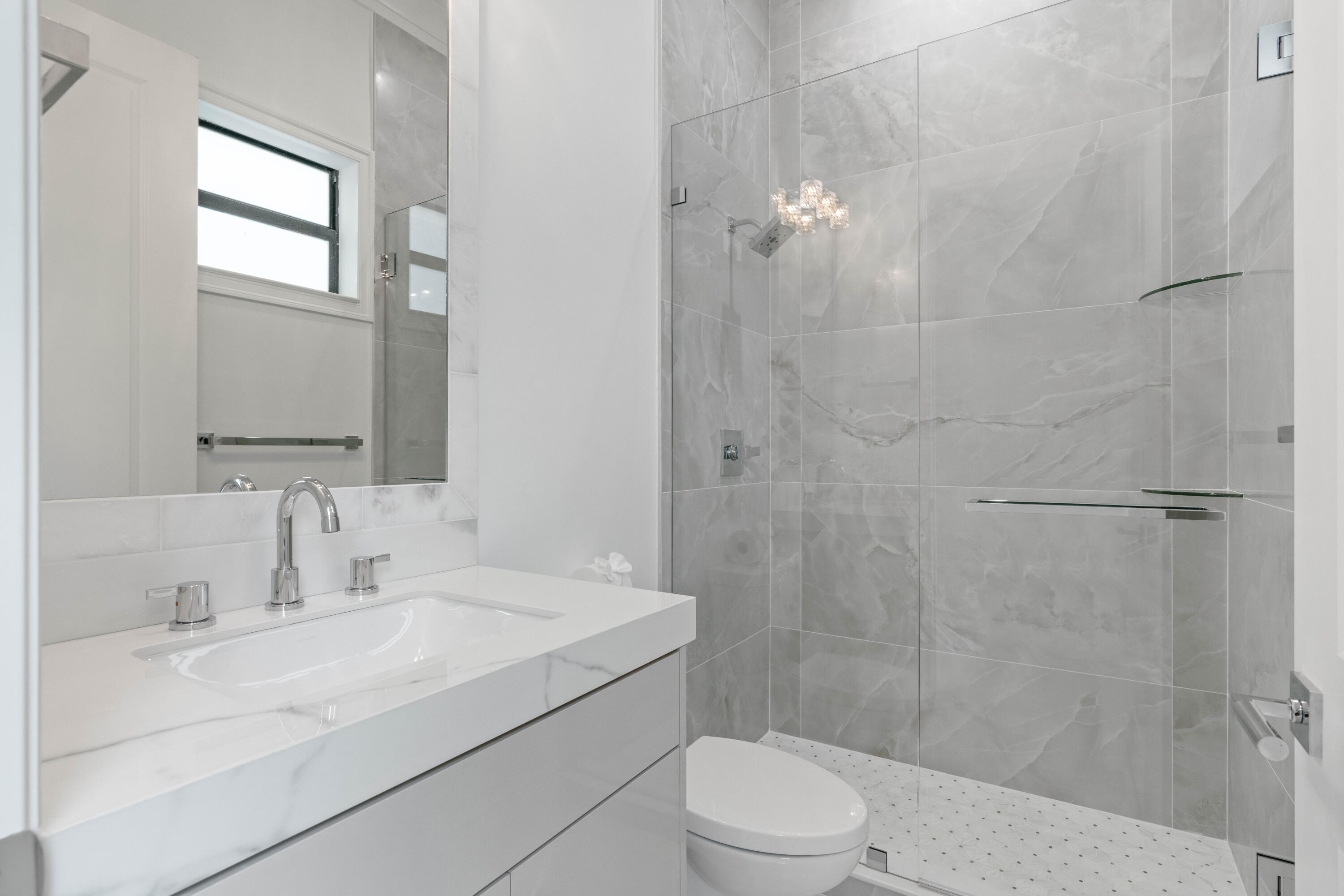 17794 Mellen Lane Jupiter, FL 33478 - Photo 38 of 45 a bathroom with a sink a toilet and shower